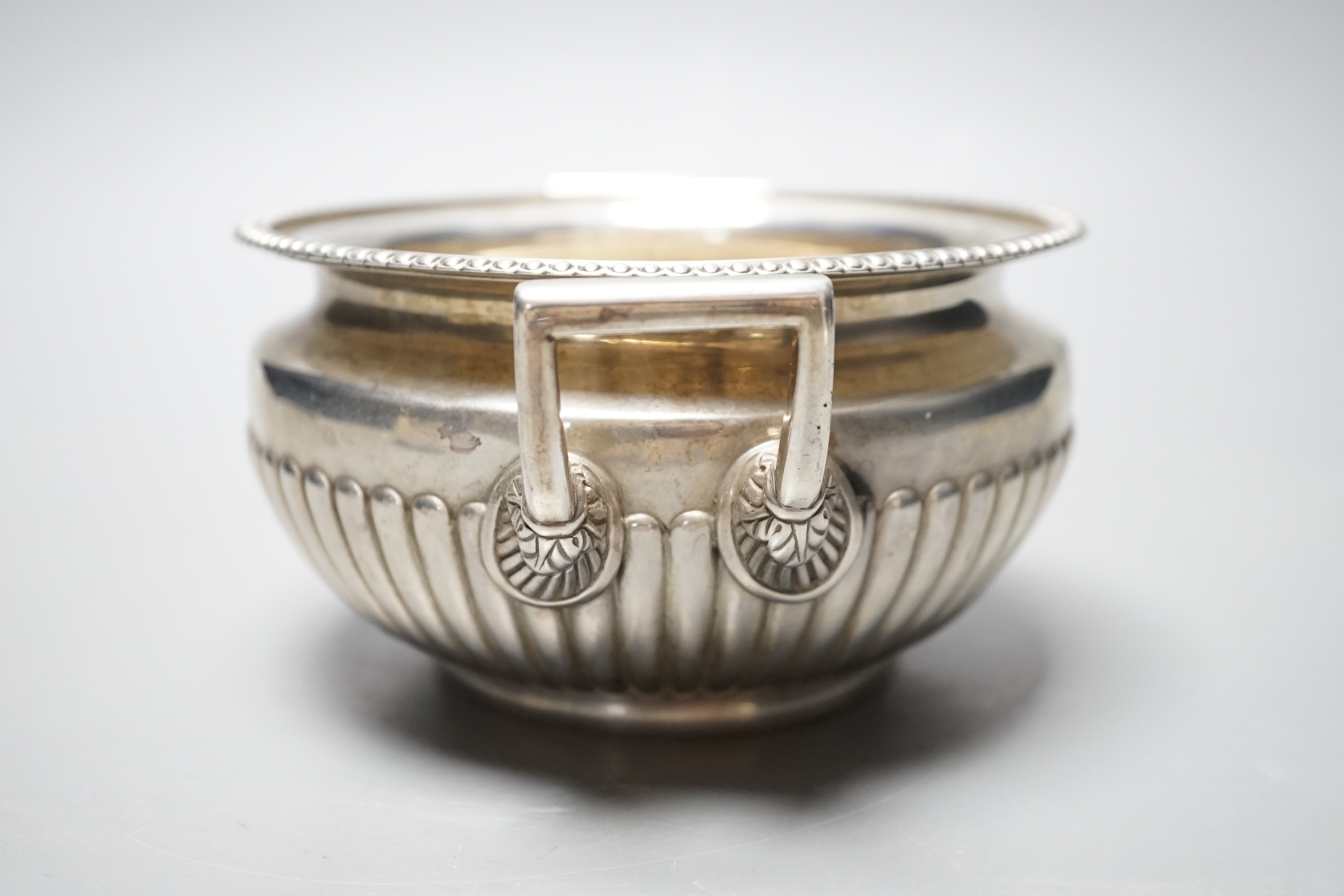 A George III demi fluted silver two handled sugar bowl, Burwash & Sibley, London, 1811, 16.8cm over handles